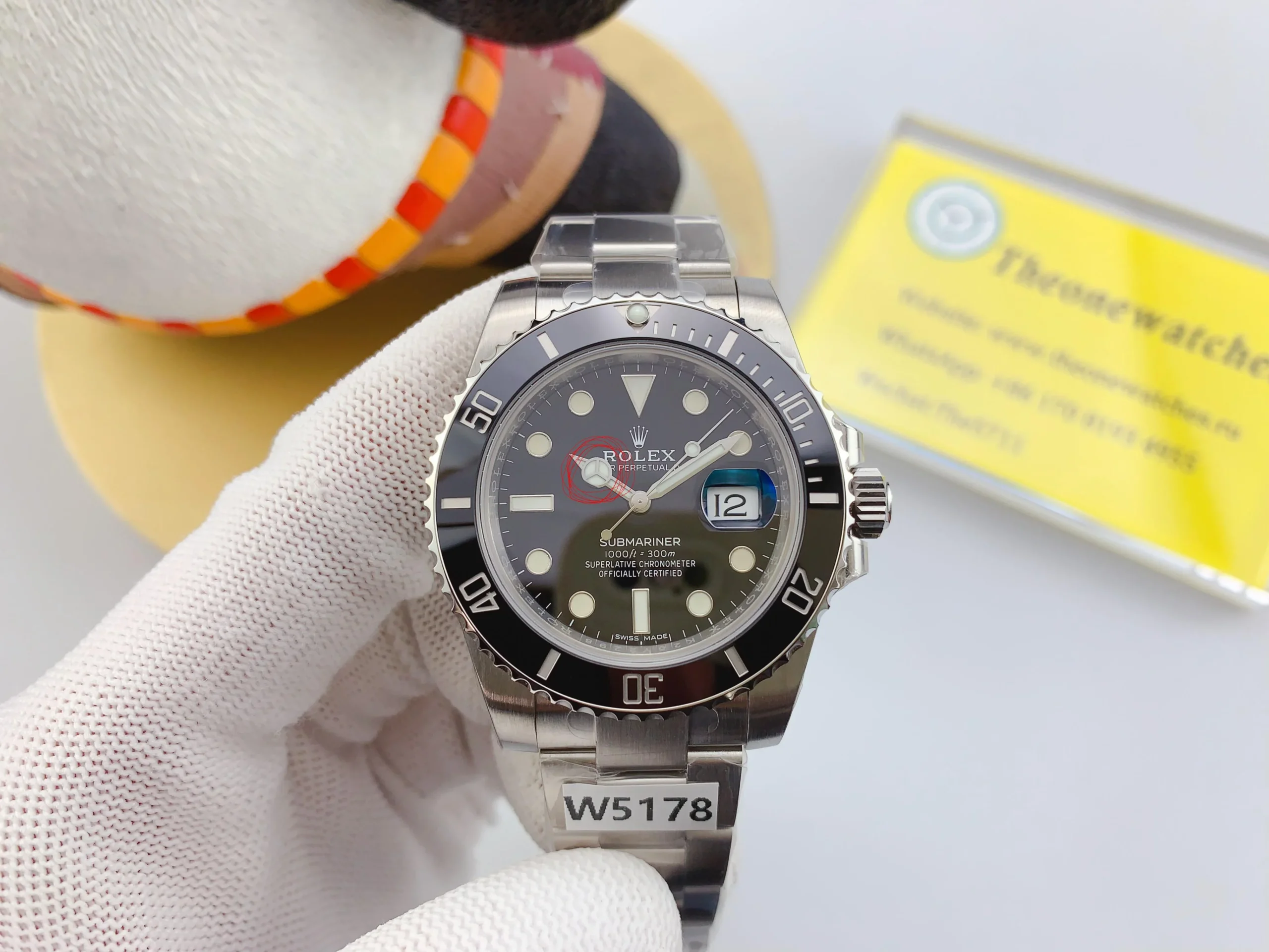 VSF Submariner 116610LN held in hand, displaying the black dial and cyclops date magnifier.