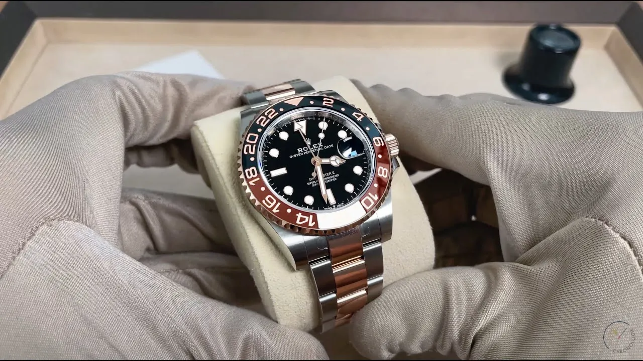 Gloved hands holding Root Beer GMT superclone to showcase case side profile and crown detail.