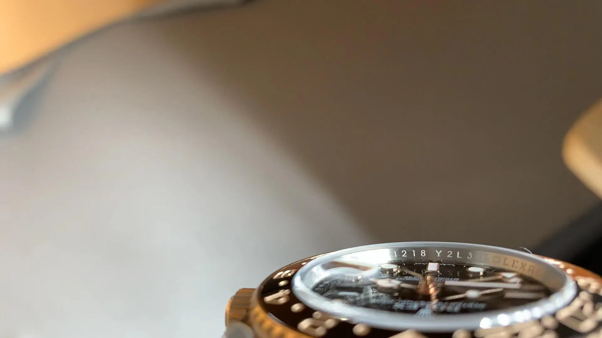 Macro view of rehaut engraving and crystal on Root Beer GMT superclone highlighting serial and Rolex text accuracy.