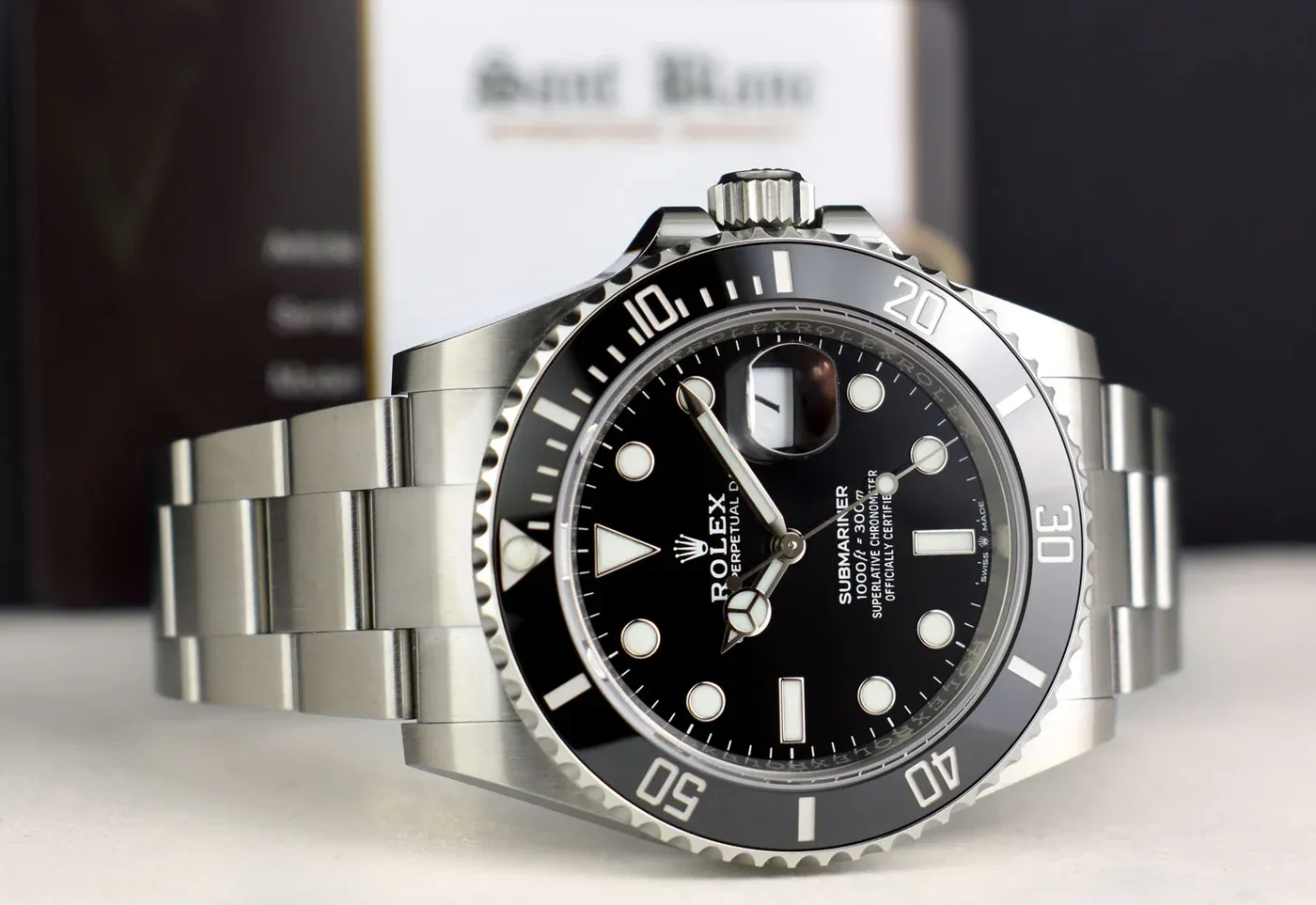 Detailed close-up of Rolex Submariner superclone showing case side profile, crown, and ceramic bezel alignment.