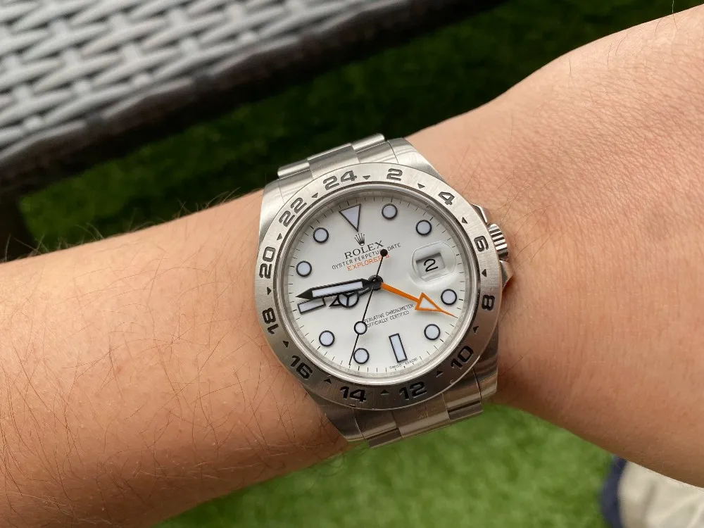 Rolex Explorer II superclone 2026 Polar white dial on wrist showing full Oyster bracelet and fixed 24-hour bezel in natural outdoor lighting.