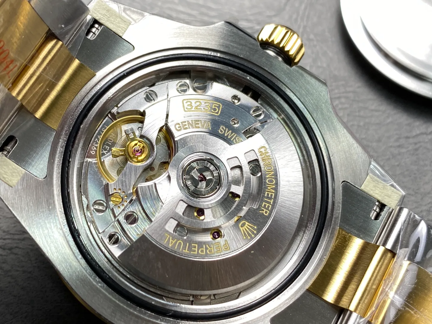 Close-up internal view of a high-end superclone Rolex movement showing the 3235 clone caliber with Geneva stripes and engravings.